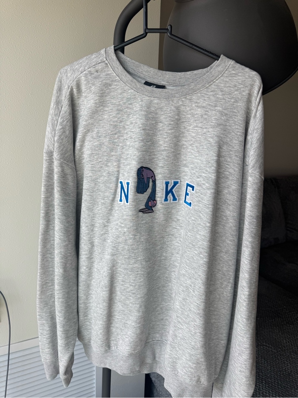 Nike Light Gray Crewneck Sweatshirt with Blue Lettering and Purple Graphic